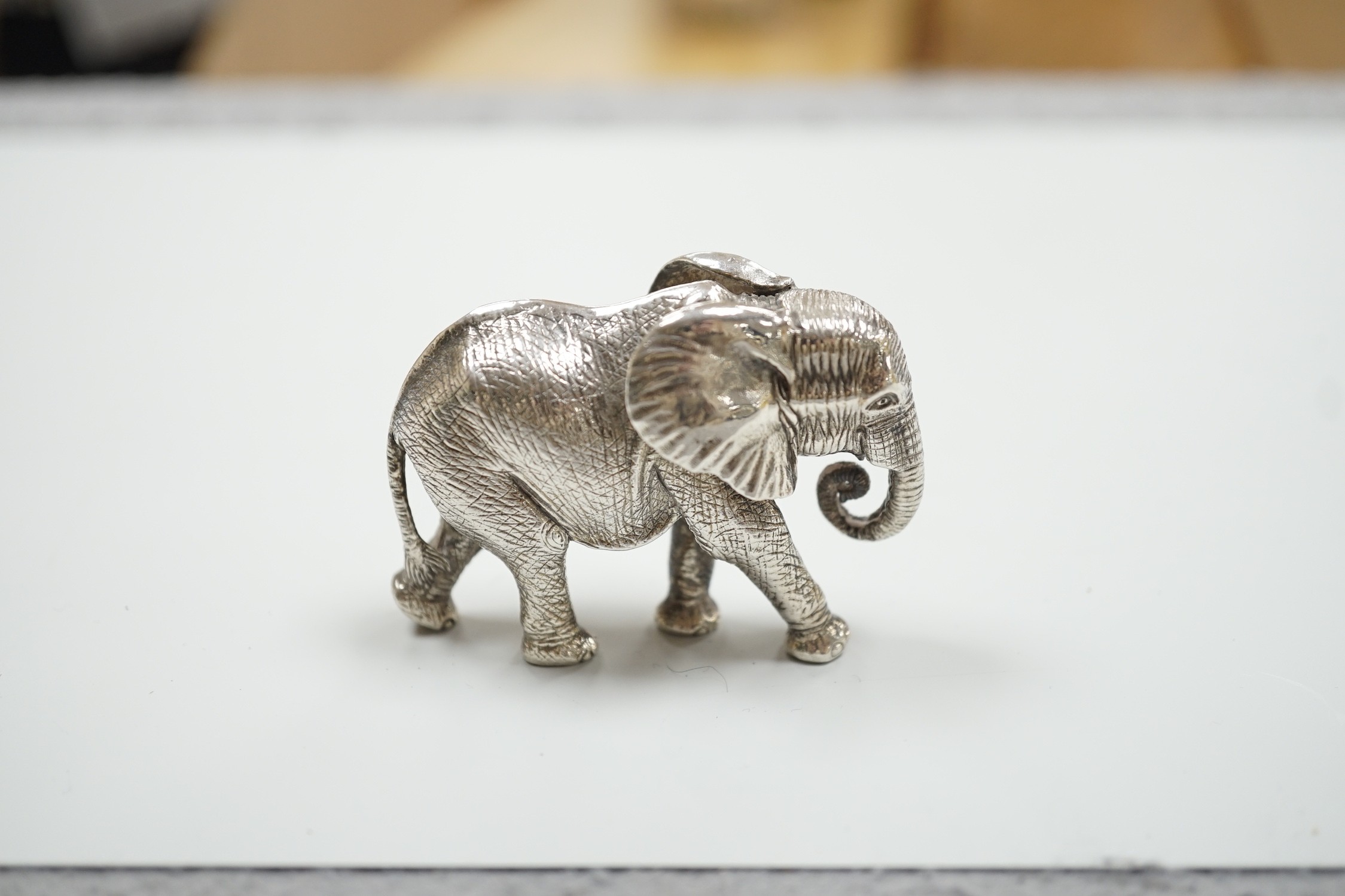 A modern Patrick Mavros miniature 925 model of an elephant, stamped 'Hasha', length 62mm, 219 grams.